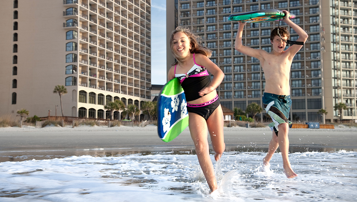 Kids on the beach at Beach Cove Resort