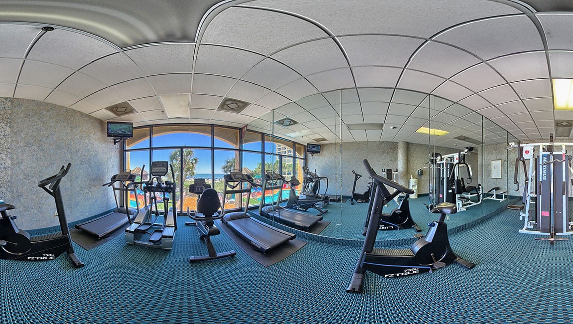 A fitness center with exercise equipment and a window
